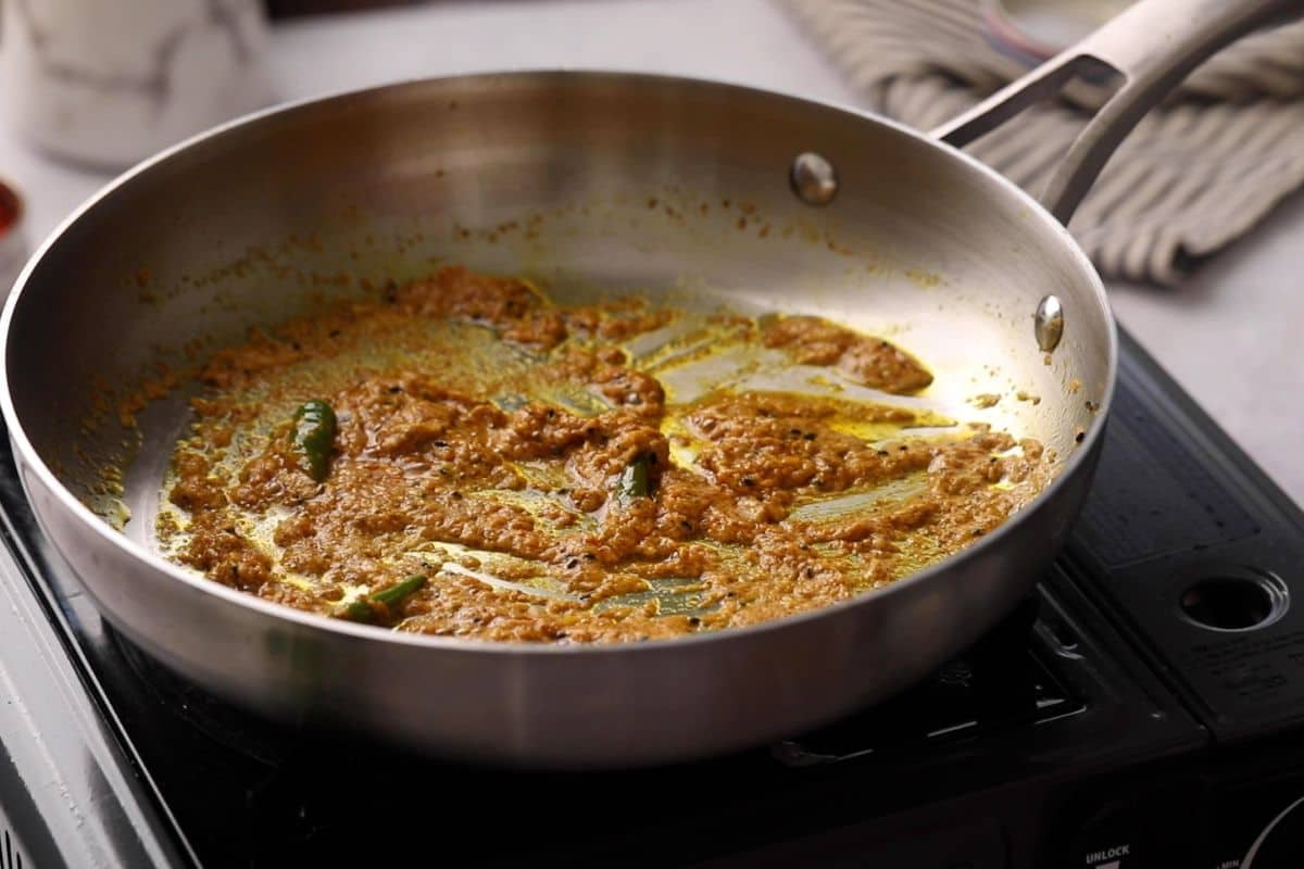 Mustard paste is cooked on low heat.