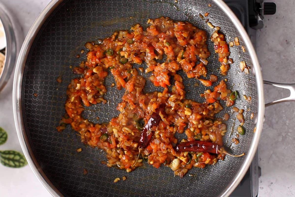 Tomatoes are cooked until they soften.