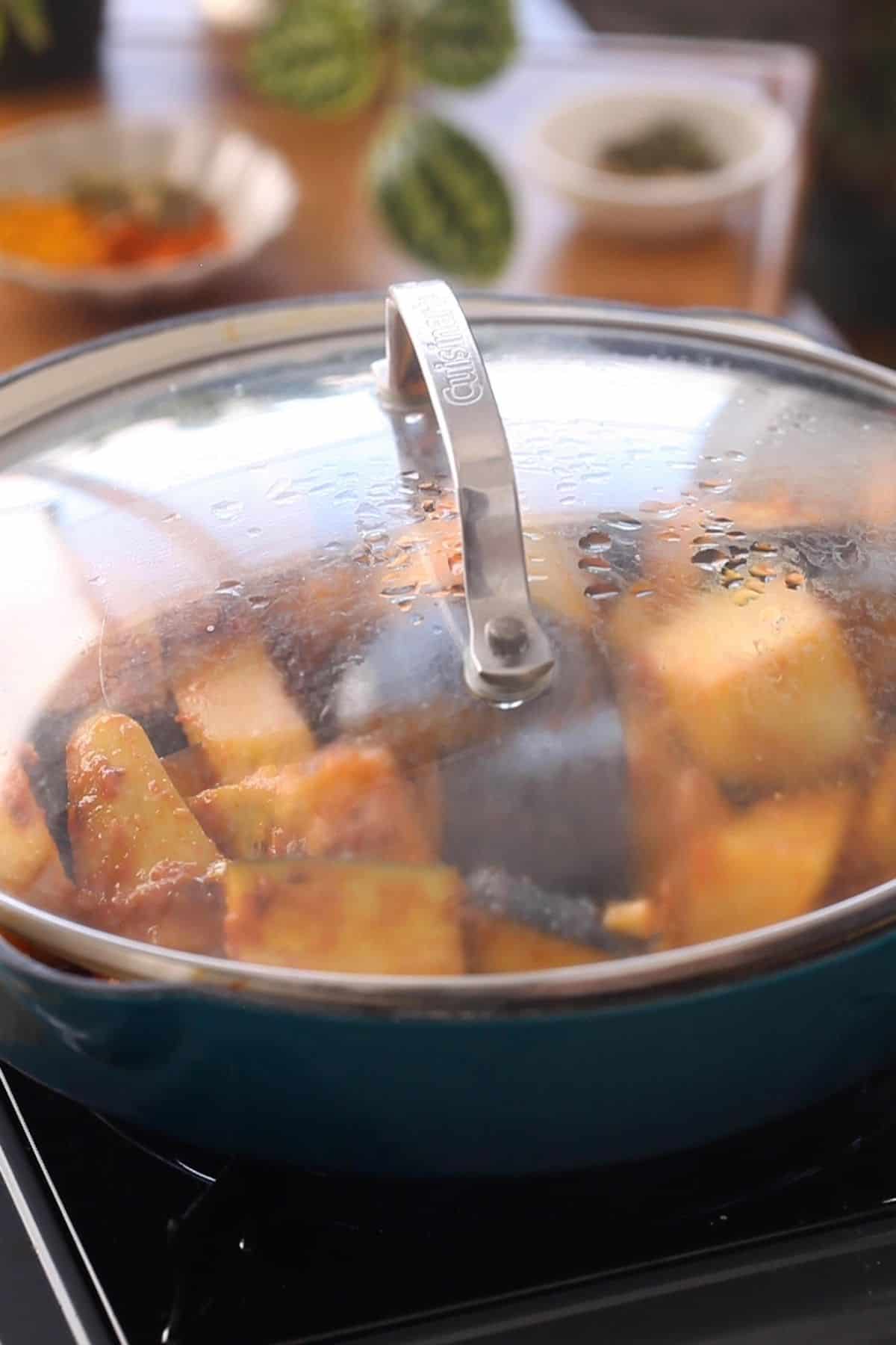 Cover and let cook till eggplant and potato are tender.