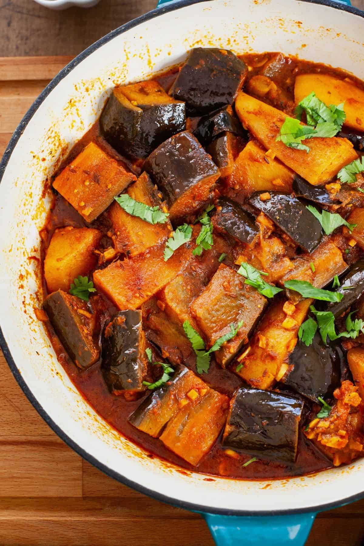 Punjabi baingan aloo a blue enamaled cast iron pan.