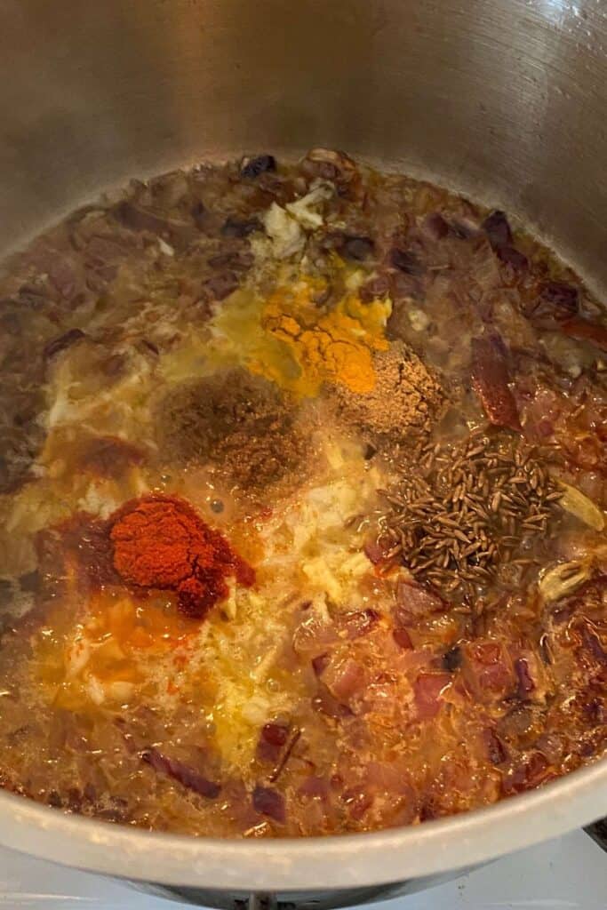 Add powdered spices to make masala base of egg curry.