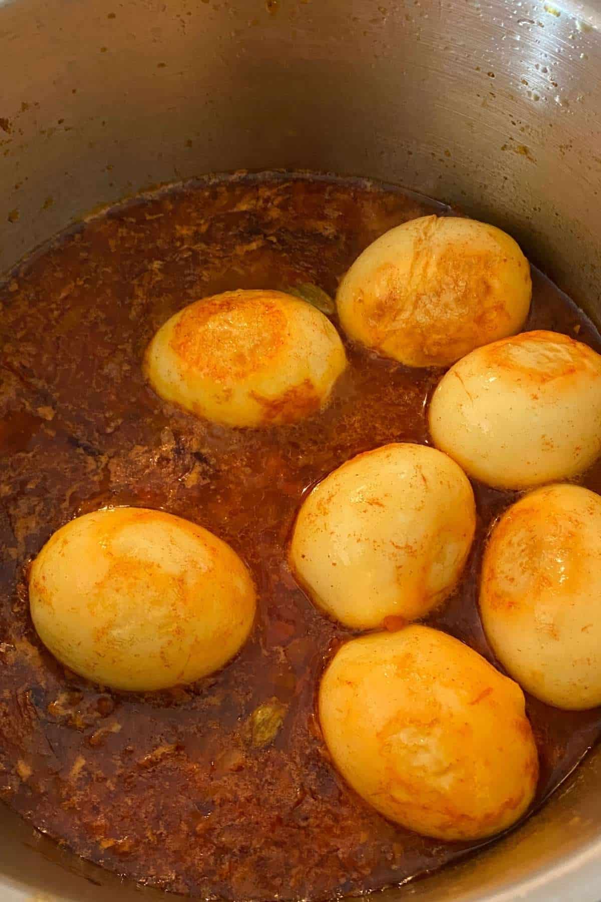 Add the boiled eggs and let simmer.