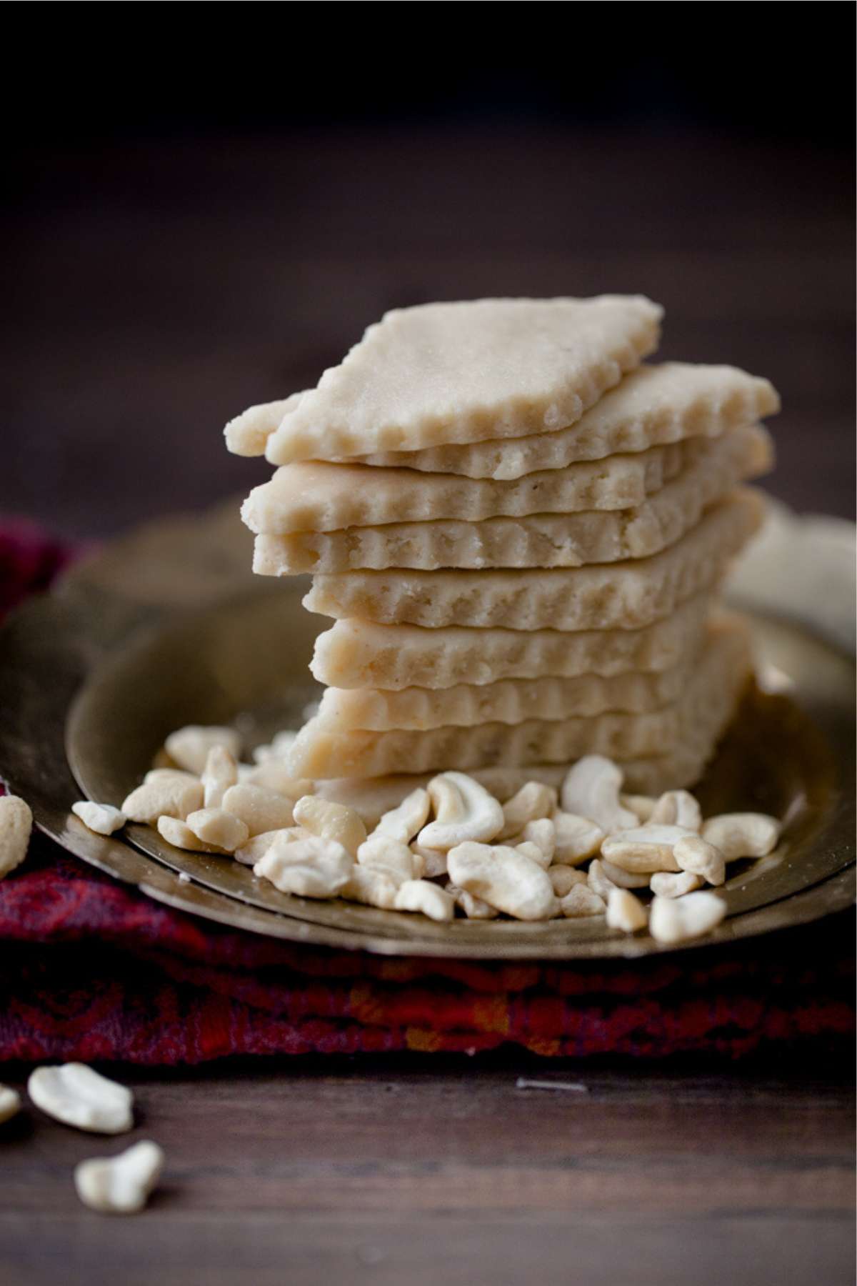 Stack of kaju katli on a brass plate.