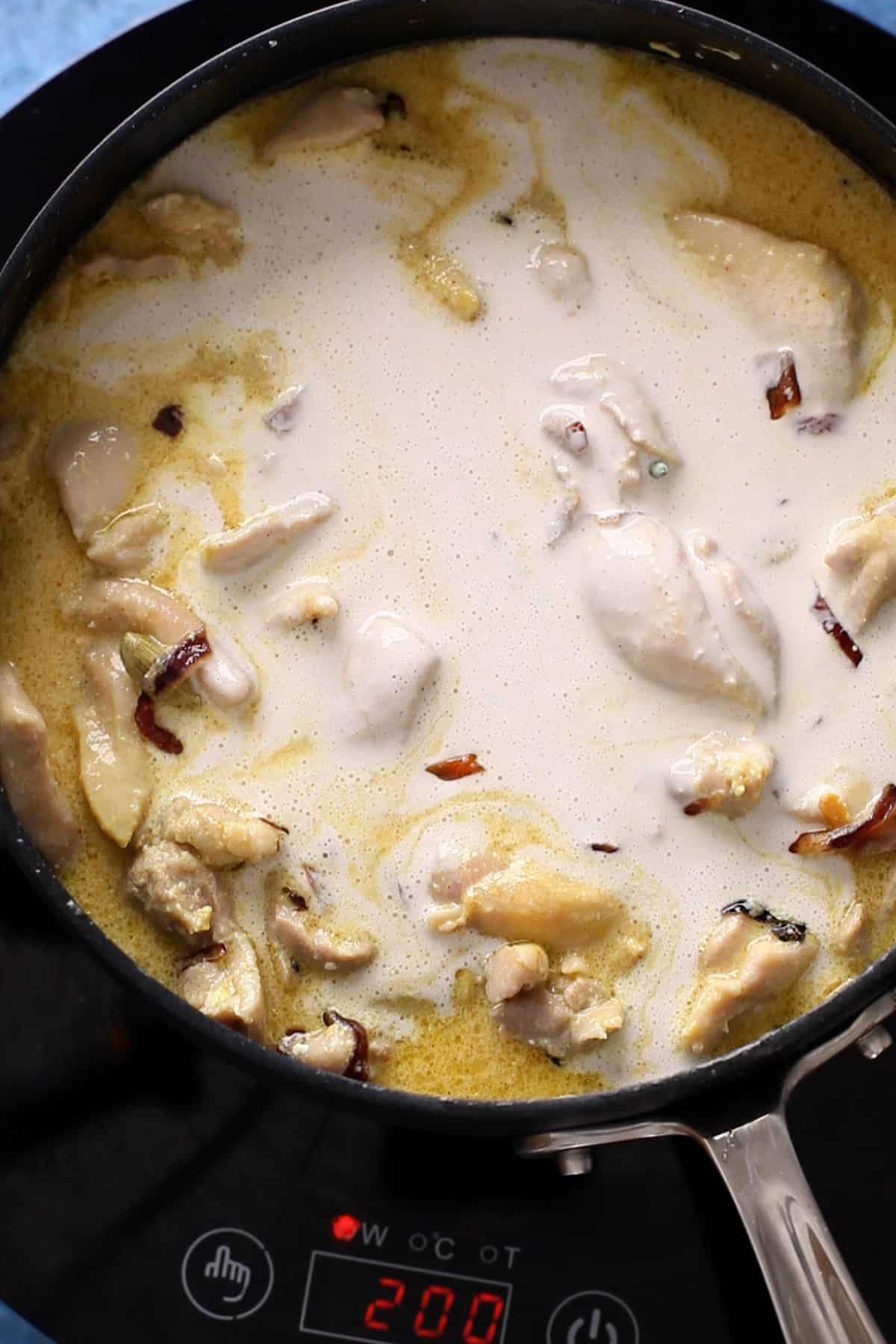 Cashew paste is added to the chicken korma.