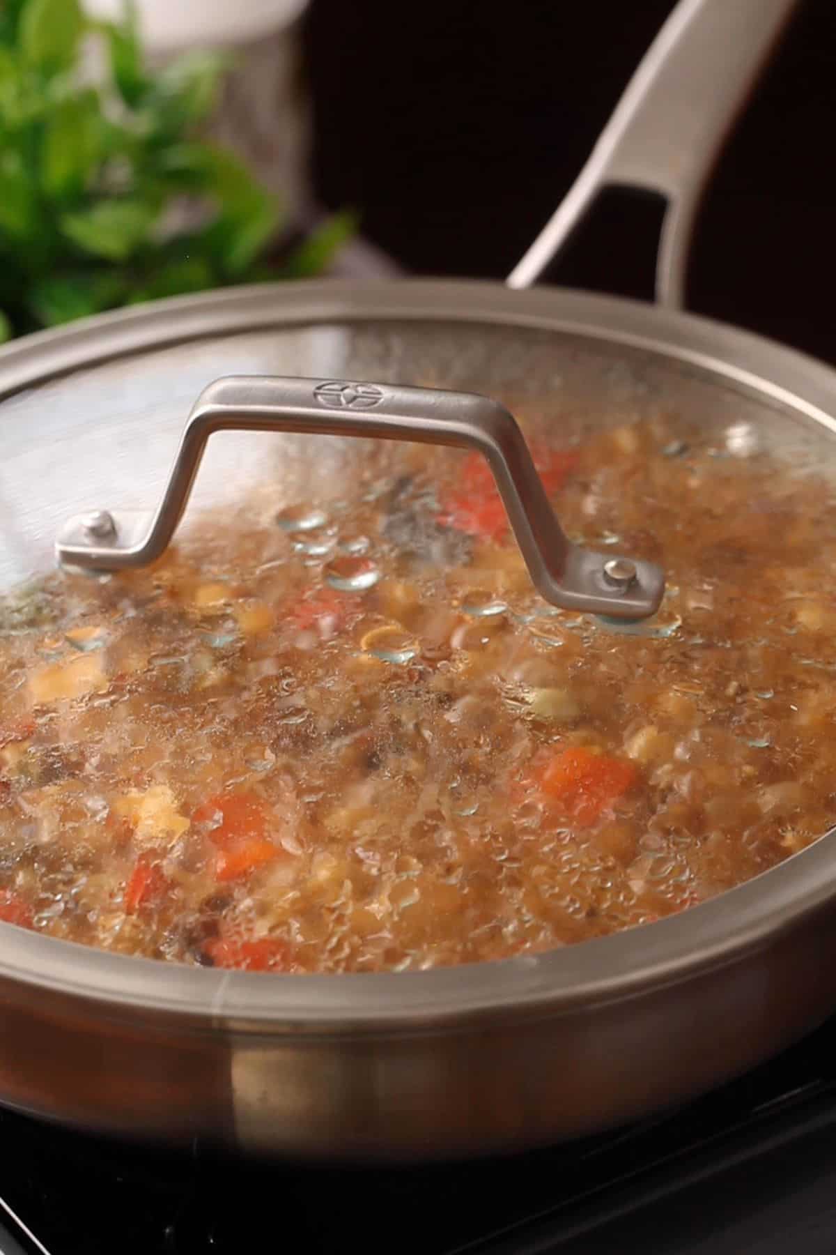 Skillet is covered to let the pulao cook.