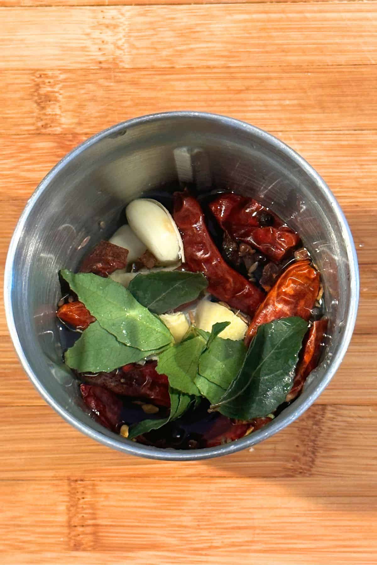 Vindaloo paste ingredients in a steel spice grinder.