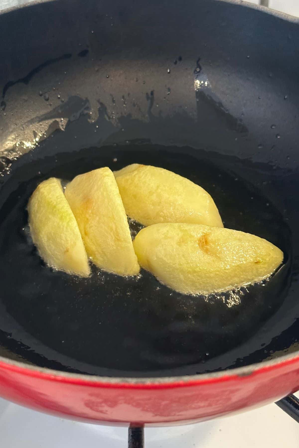 Shallow frying potatoes in oil.