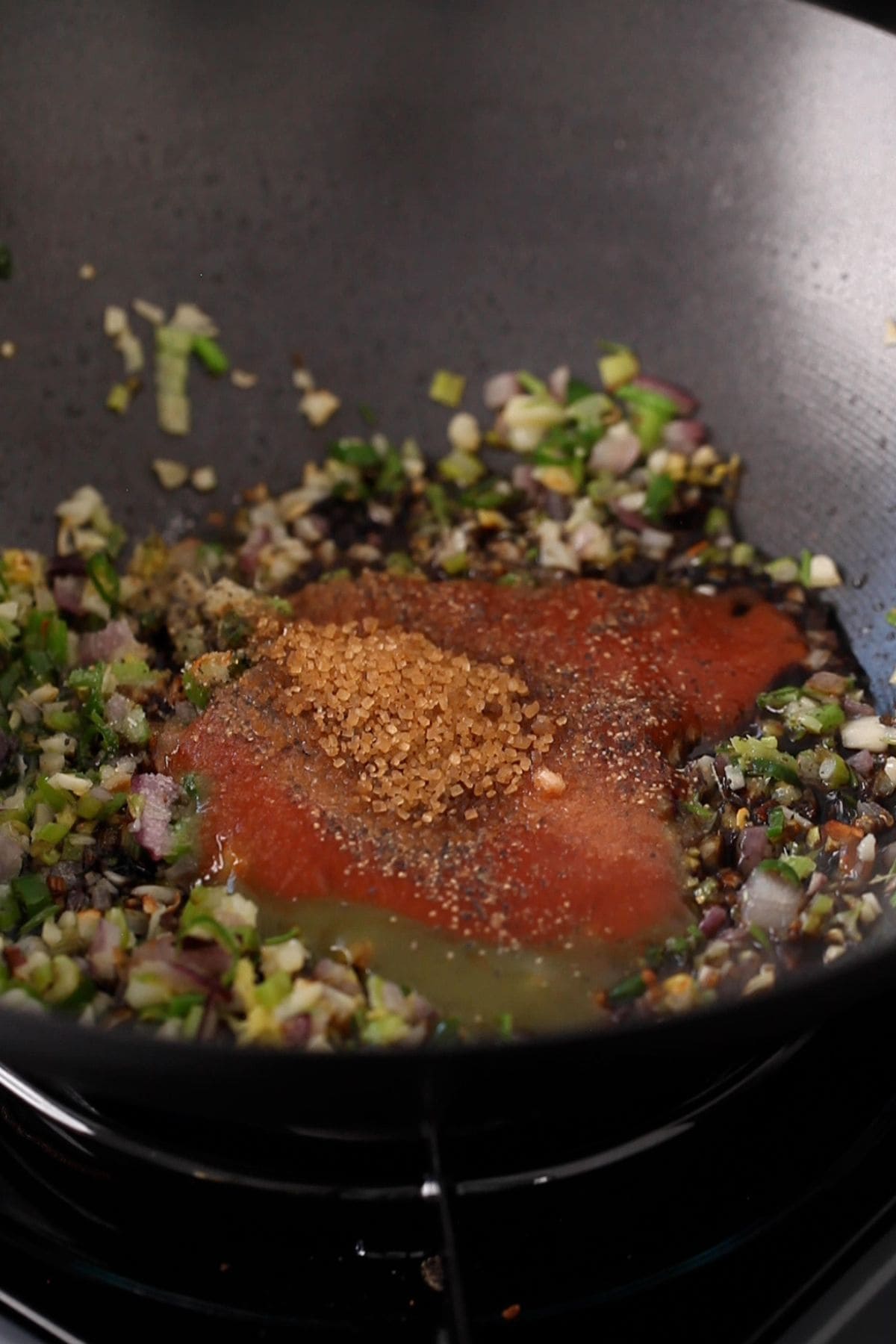 Chinese condiments, spices and sugar are added to the wok.