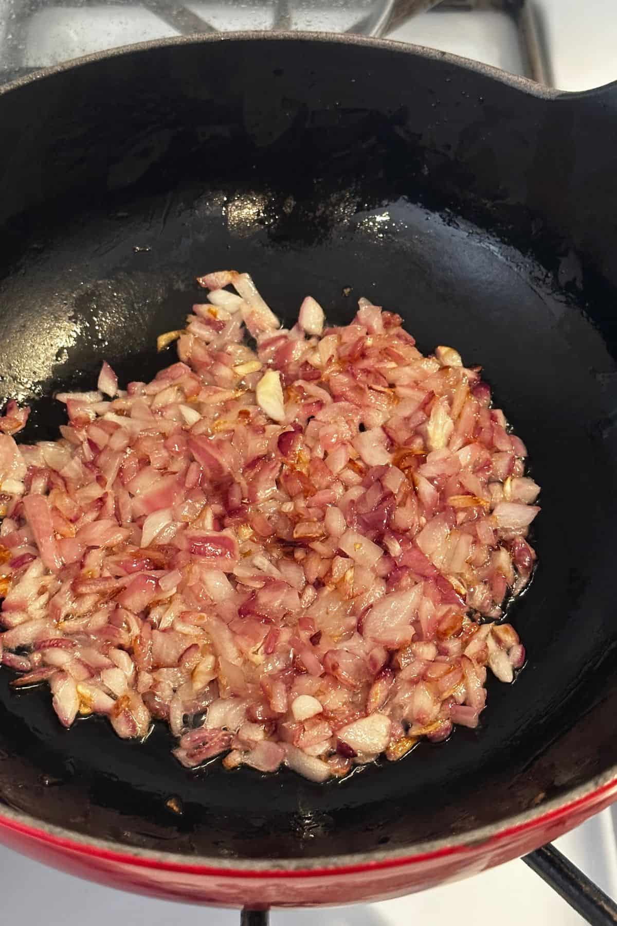 Browned onions in a cast iron balti dish.