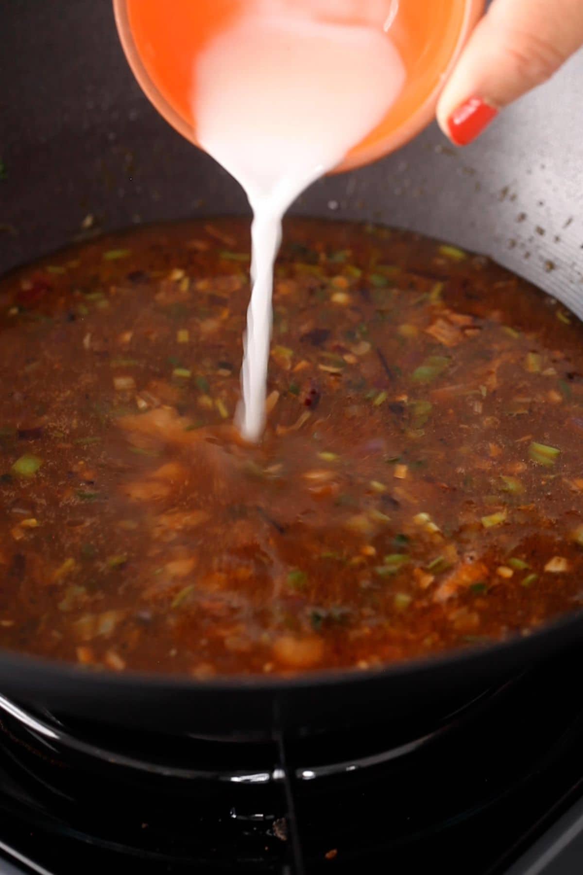 Cornstrach is added to the simmering manchurian gravy.