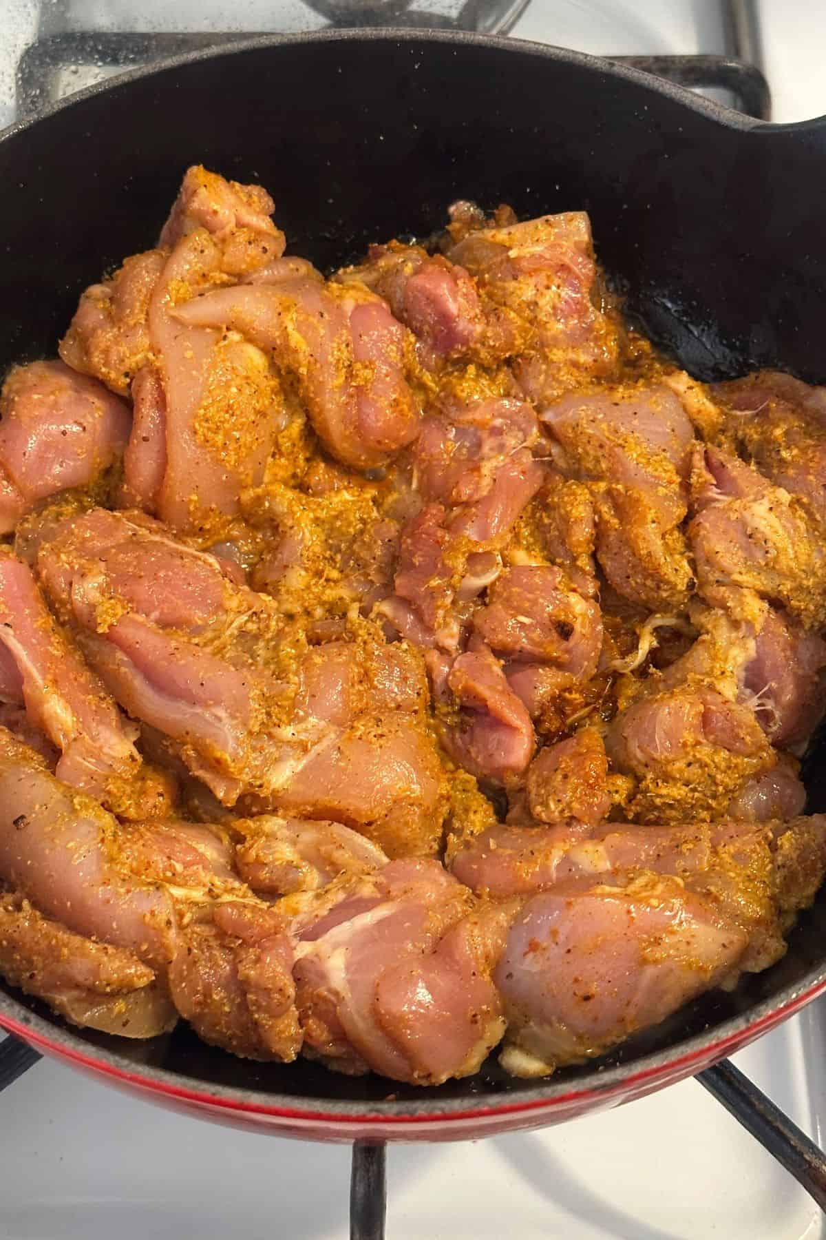 Marinated chicken is added to the masala.