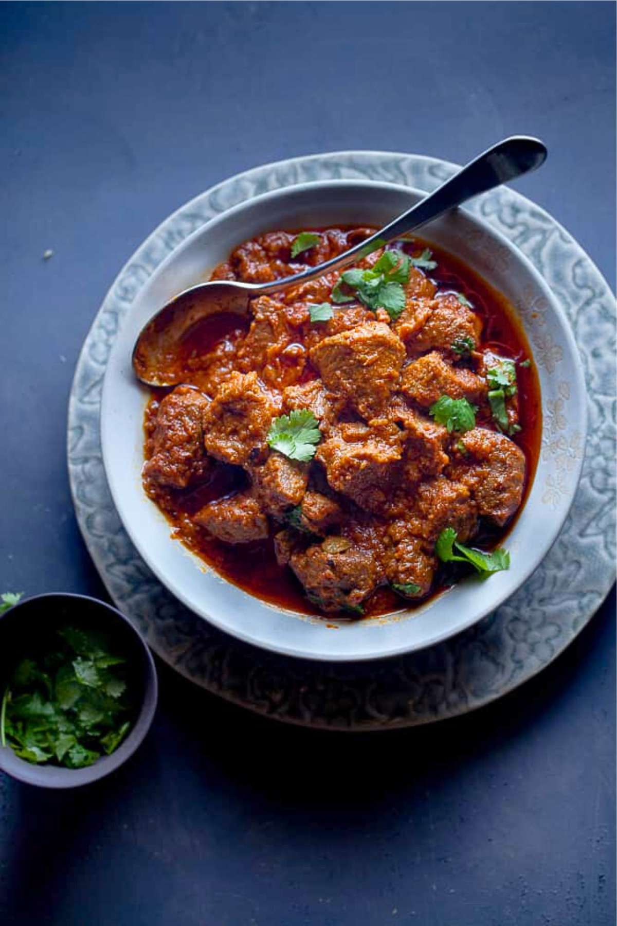 Lamb Rogan Josh served in a grey plate.