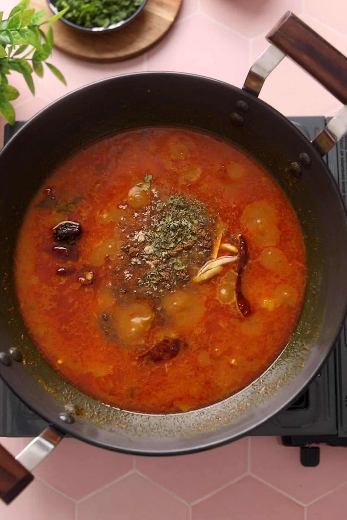 Finishing spices are added to aloo puri sabzi.
