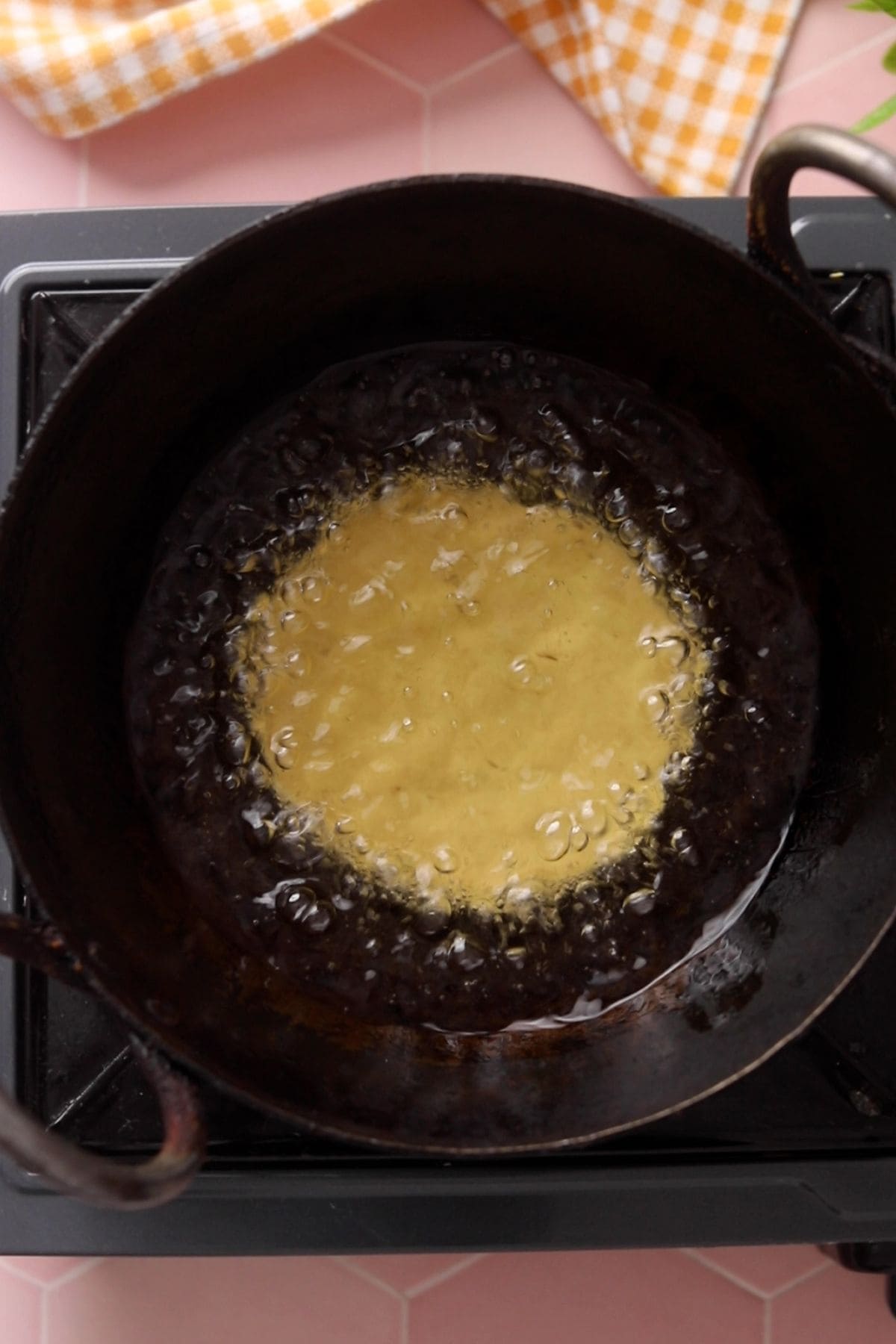 Rolled poori is lowered in hot oil.