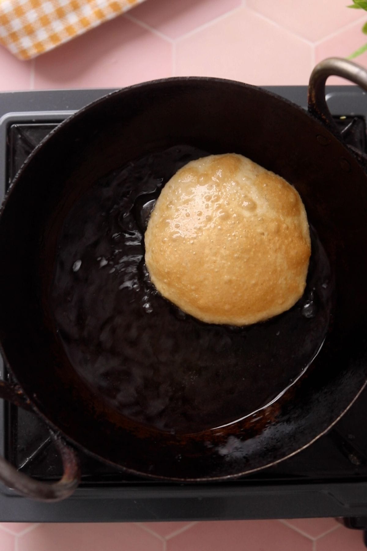 Poori is puffed and golden.