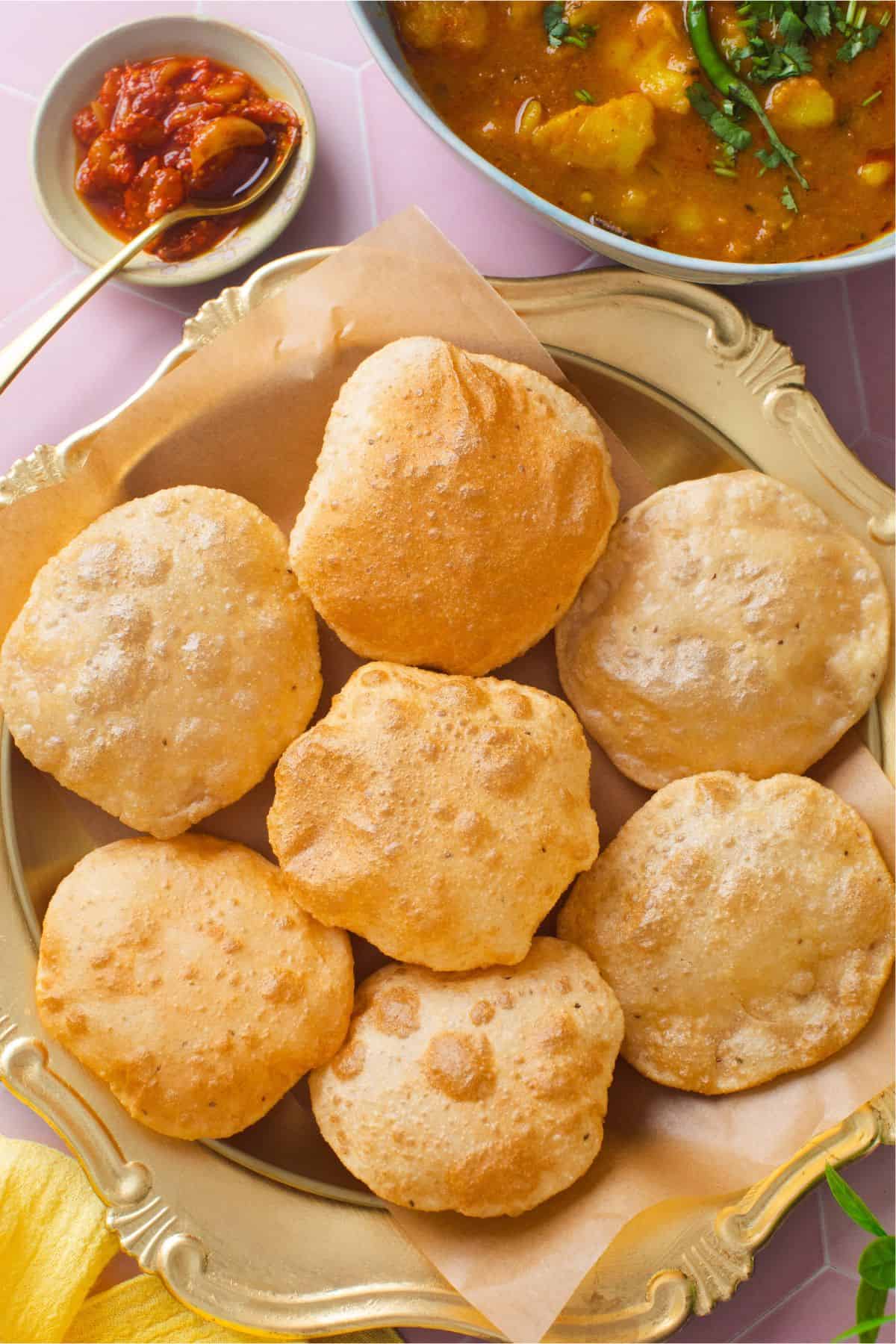 Poori placed in a gold plate. 