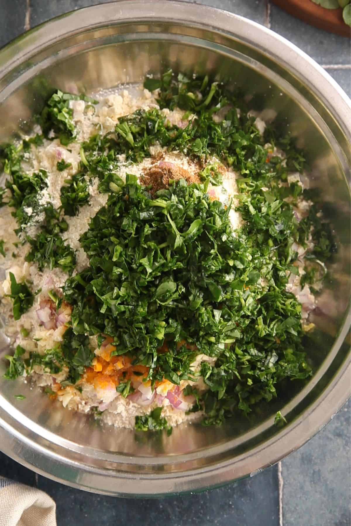 All ingredients are added to a large steel plate. 