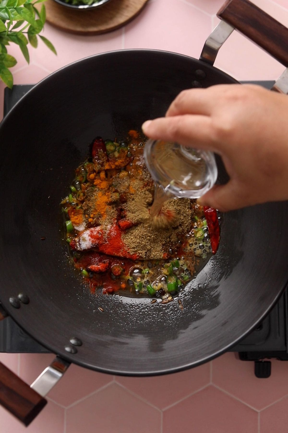 Ground spices and water are added to the whole spices.