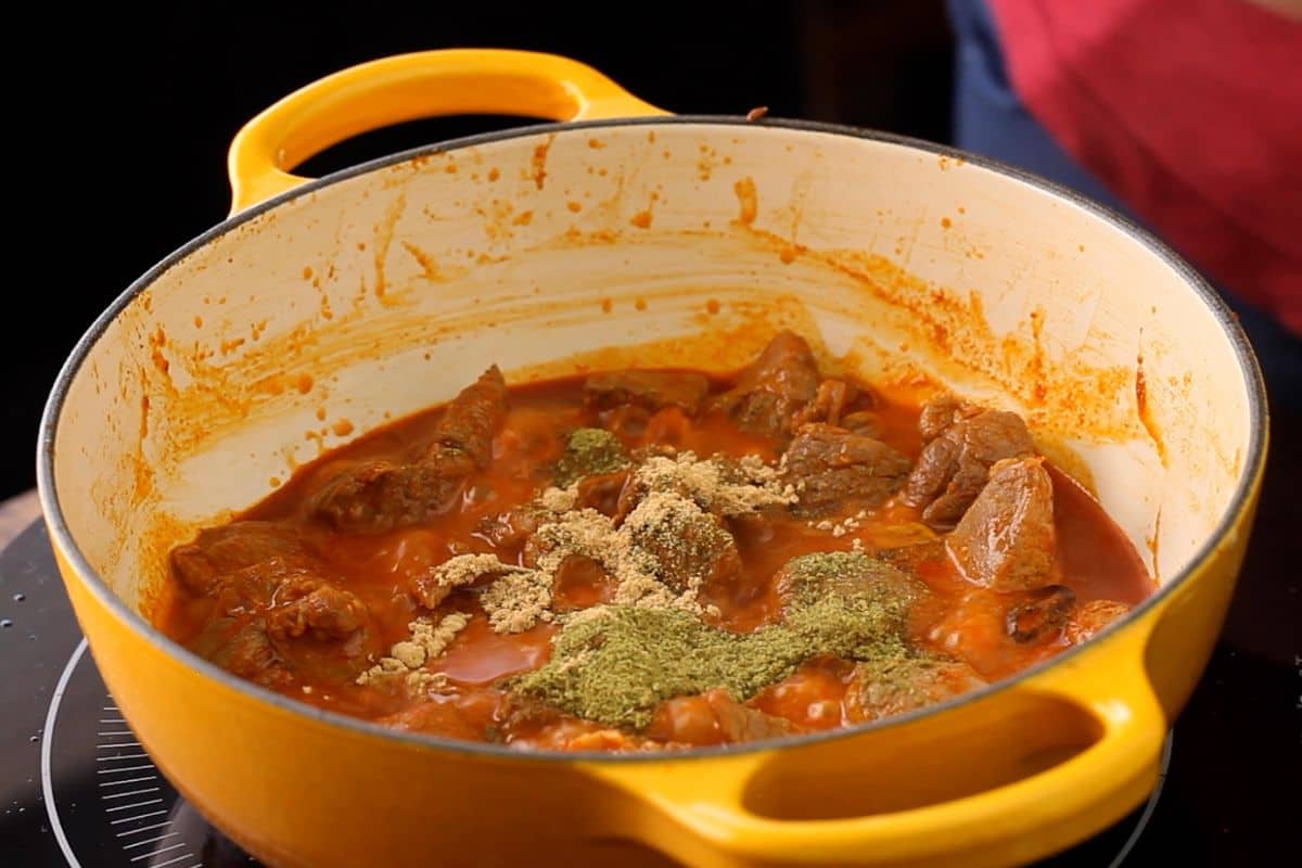 Ground spices are added to the lamb.