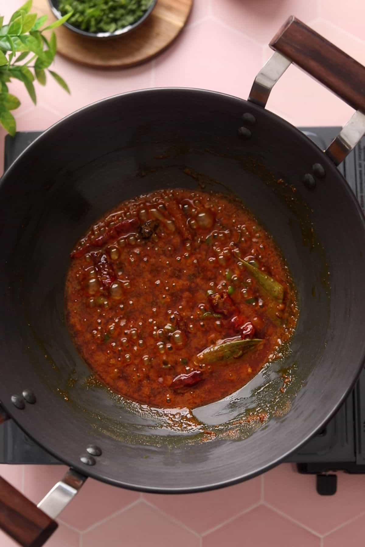 Spices are cooked and ghee is seperating.