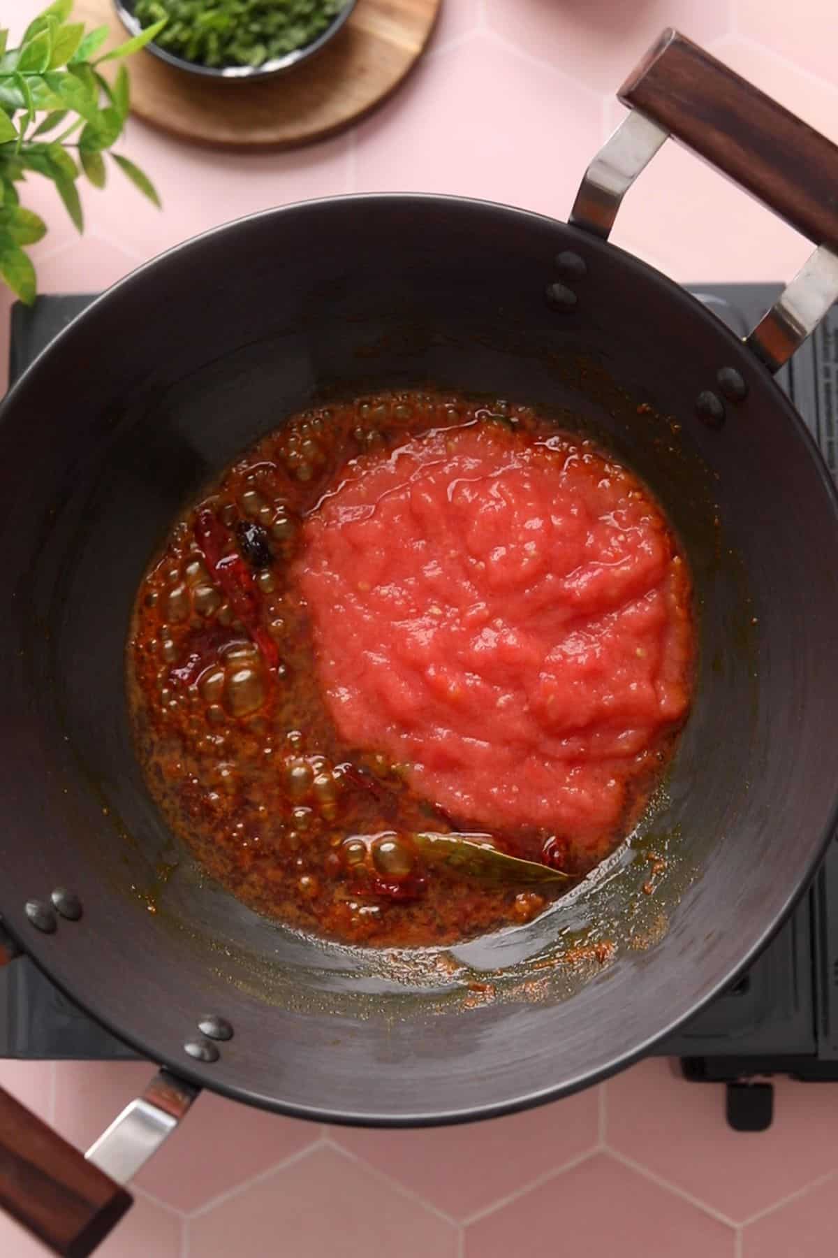 Tomatoes are added to the masala. 