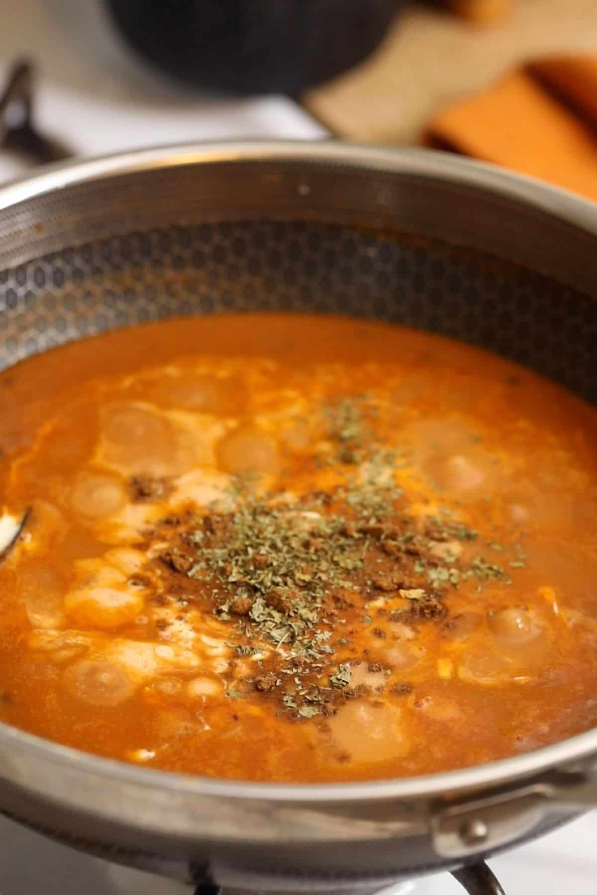 Finishing dal makhani with heavy cream, garam masala and kasuri methi.