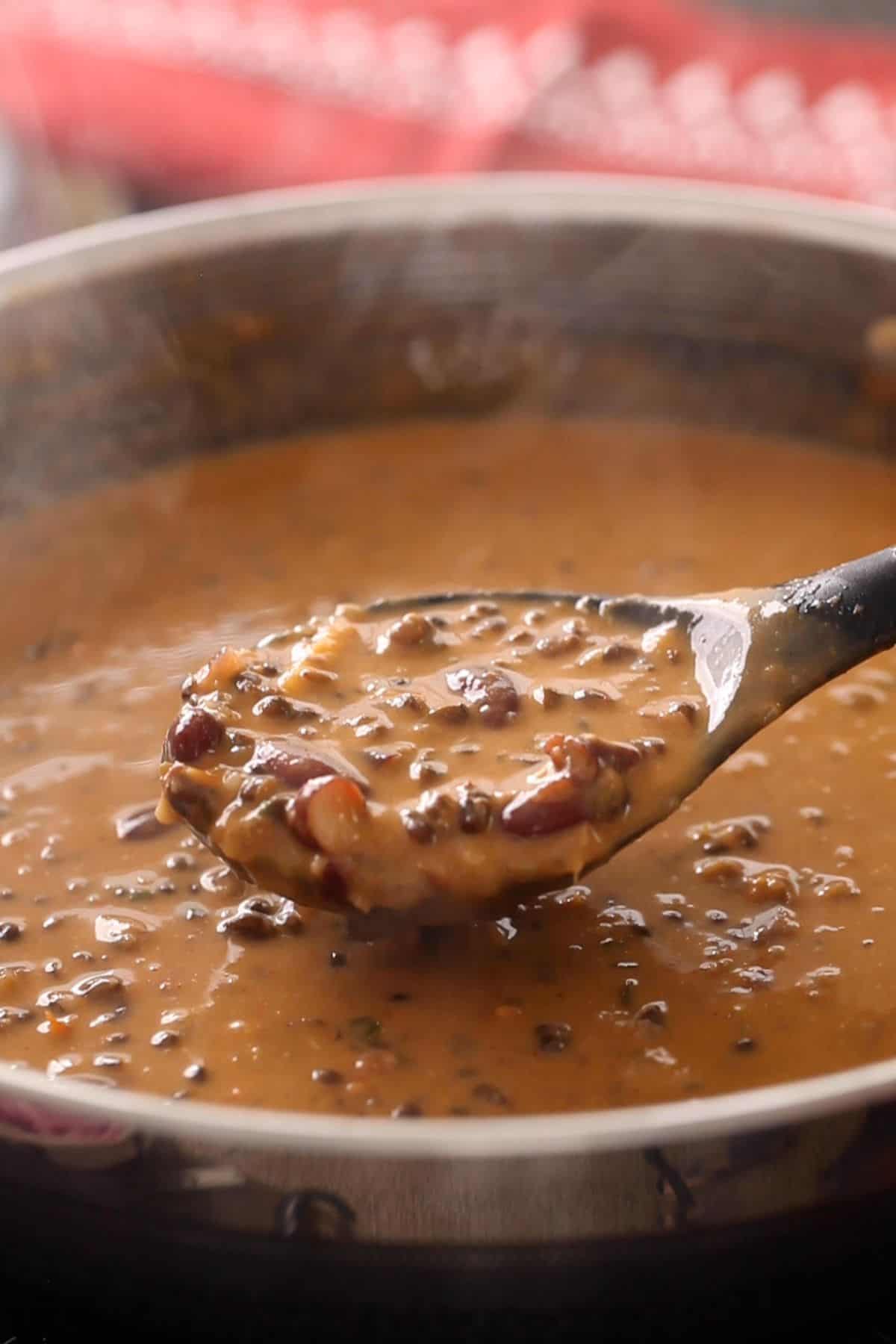 Dal makhani in a black ladle.