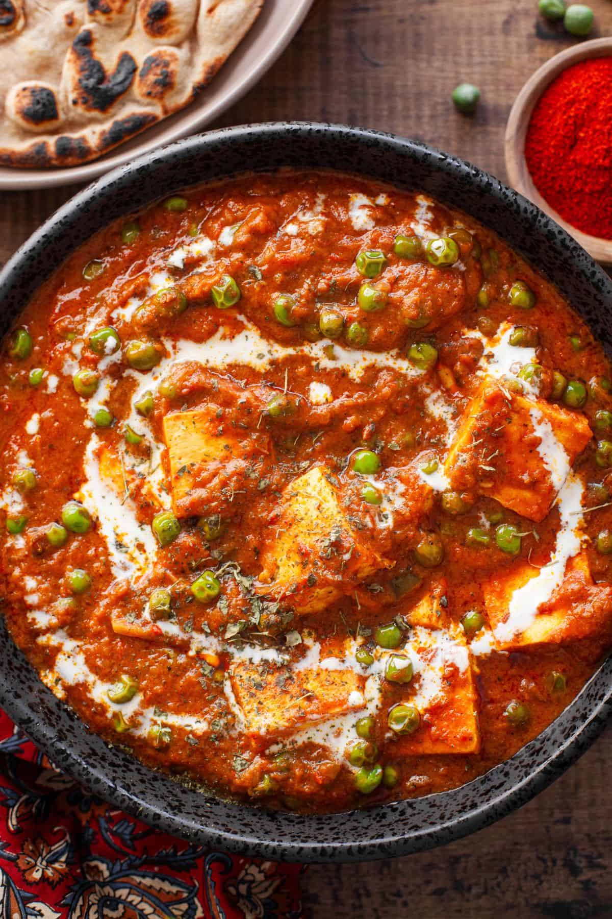 Close up of mattar paneer in a bowl. 