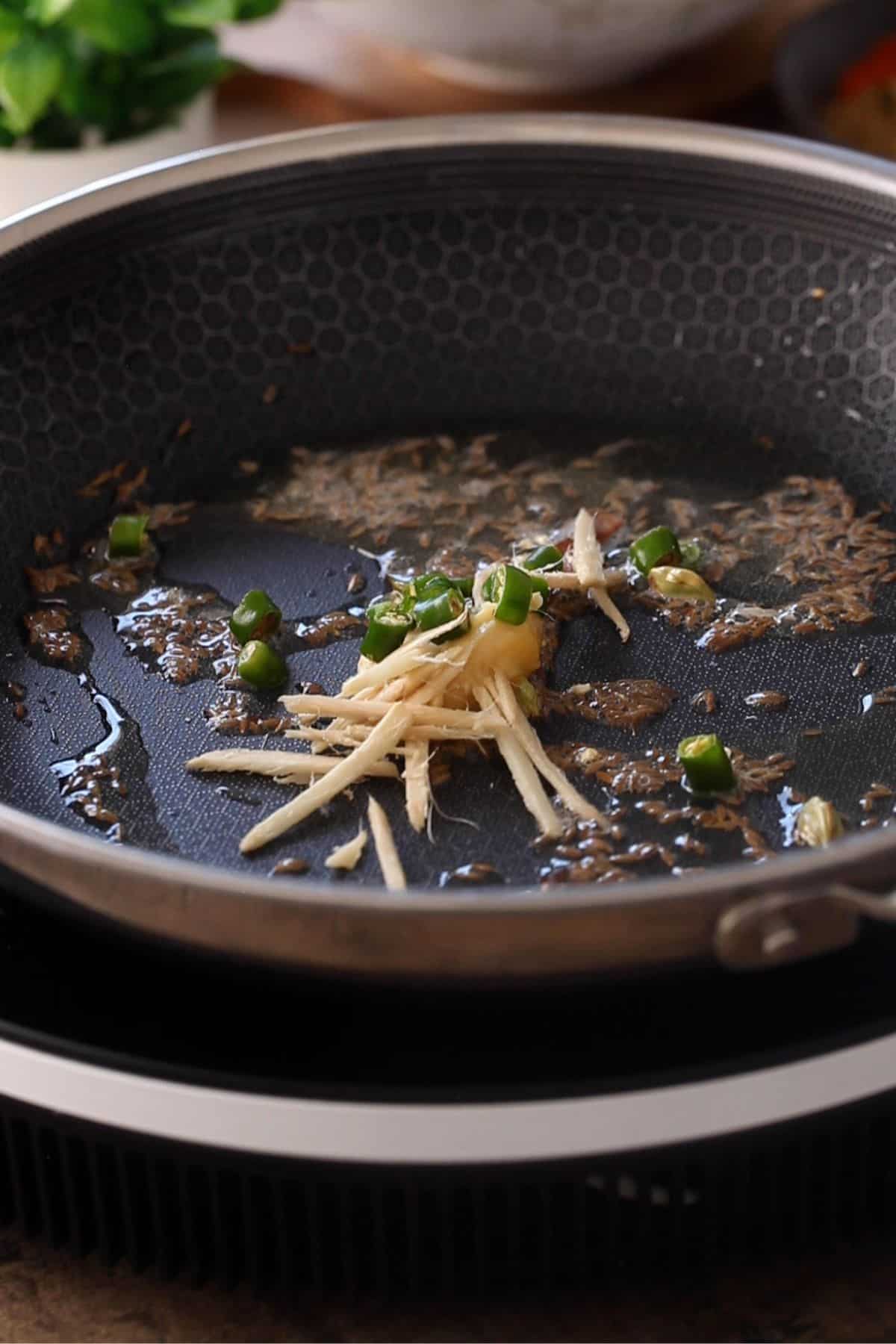 Whole spices, ginger, garlic and green chilies are fried in ghee.