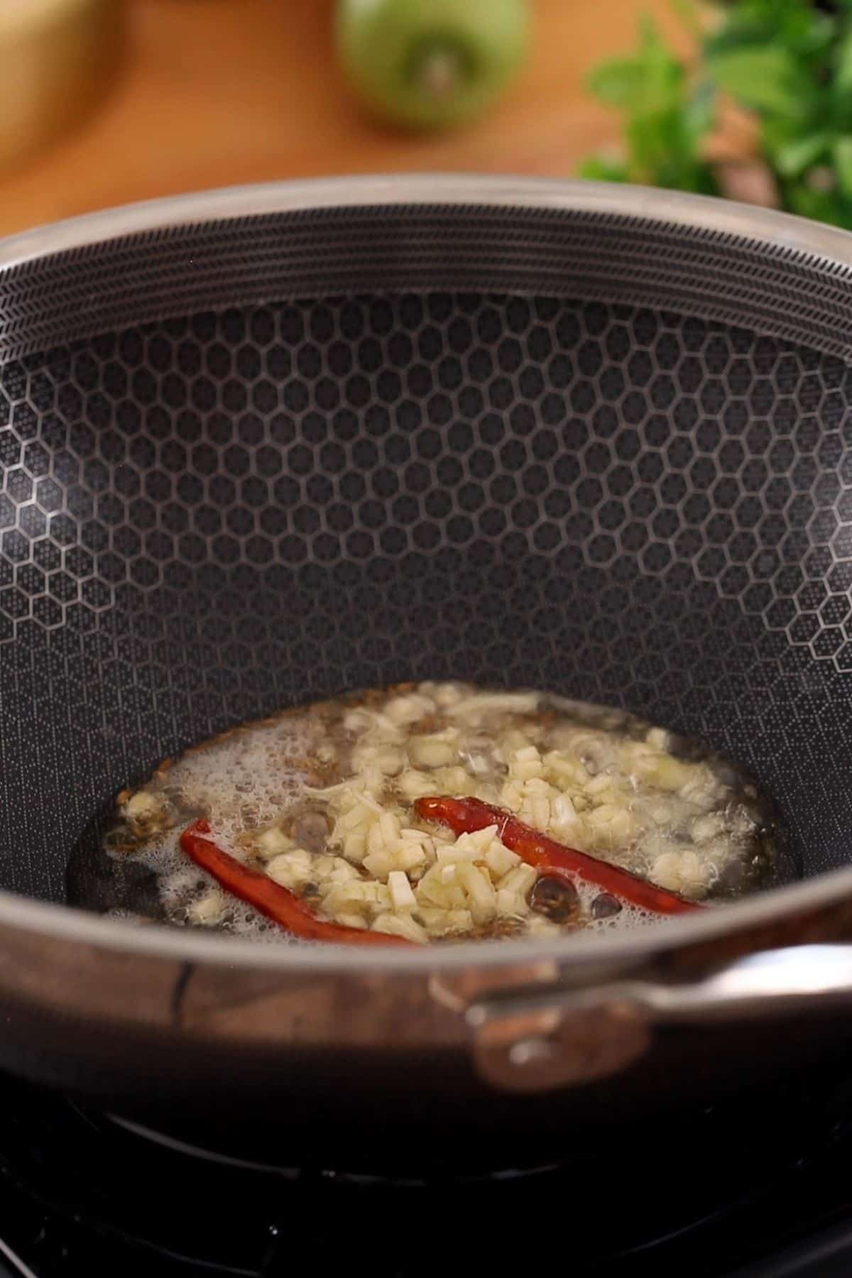 Tempering of cumin garlic and dried chillies.