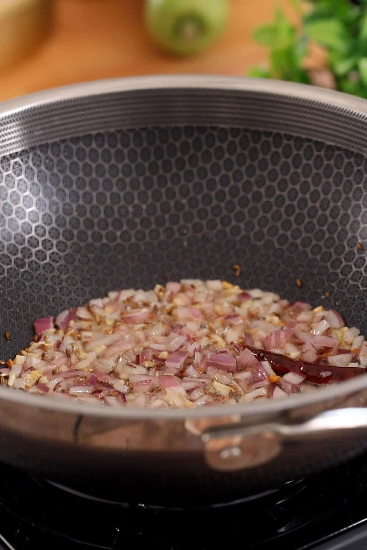 Onion is added to the tadka.