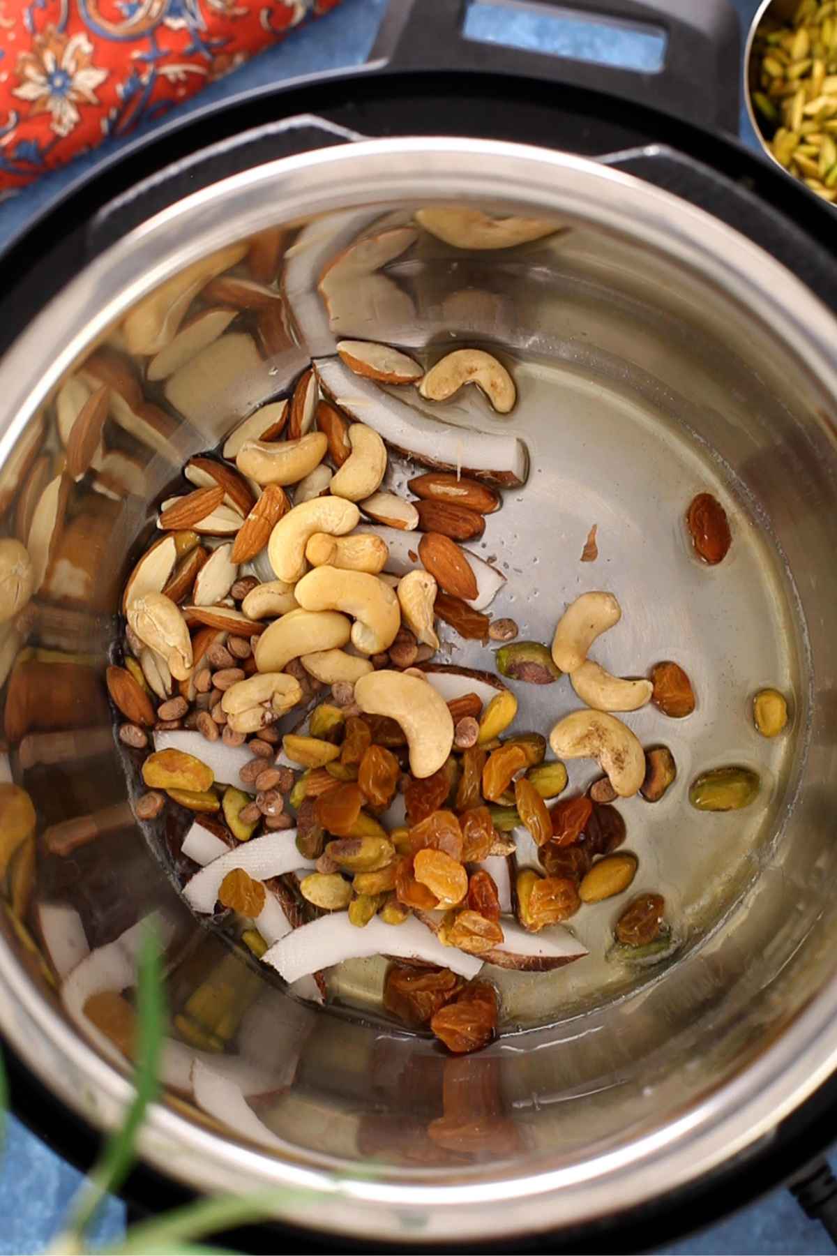 Fry whole spices and nuts in ghee.