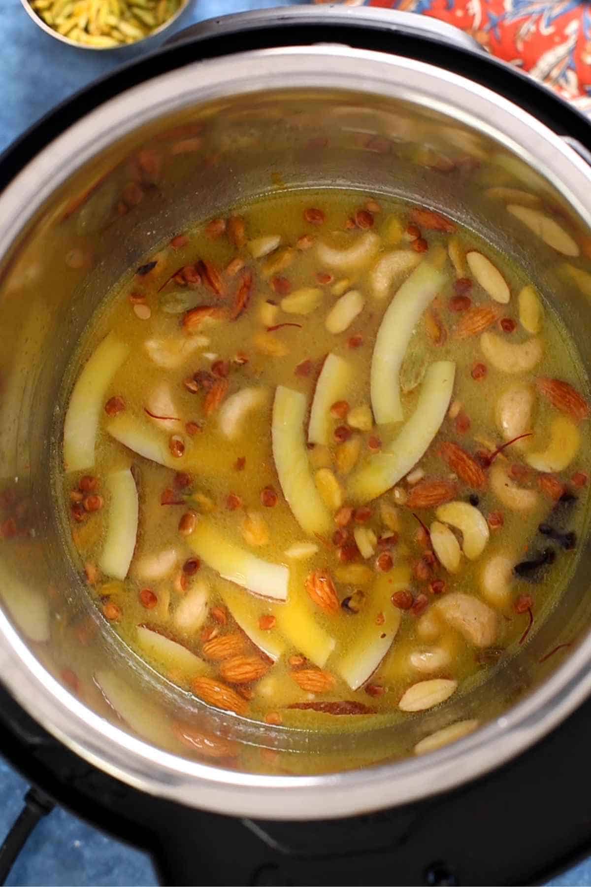 Add yellow food colouring and water to cook zarda.