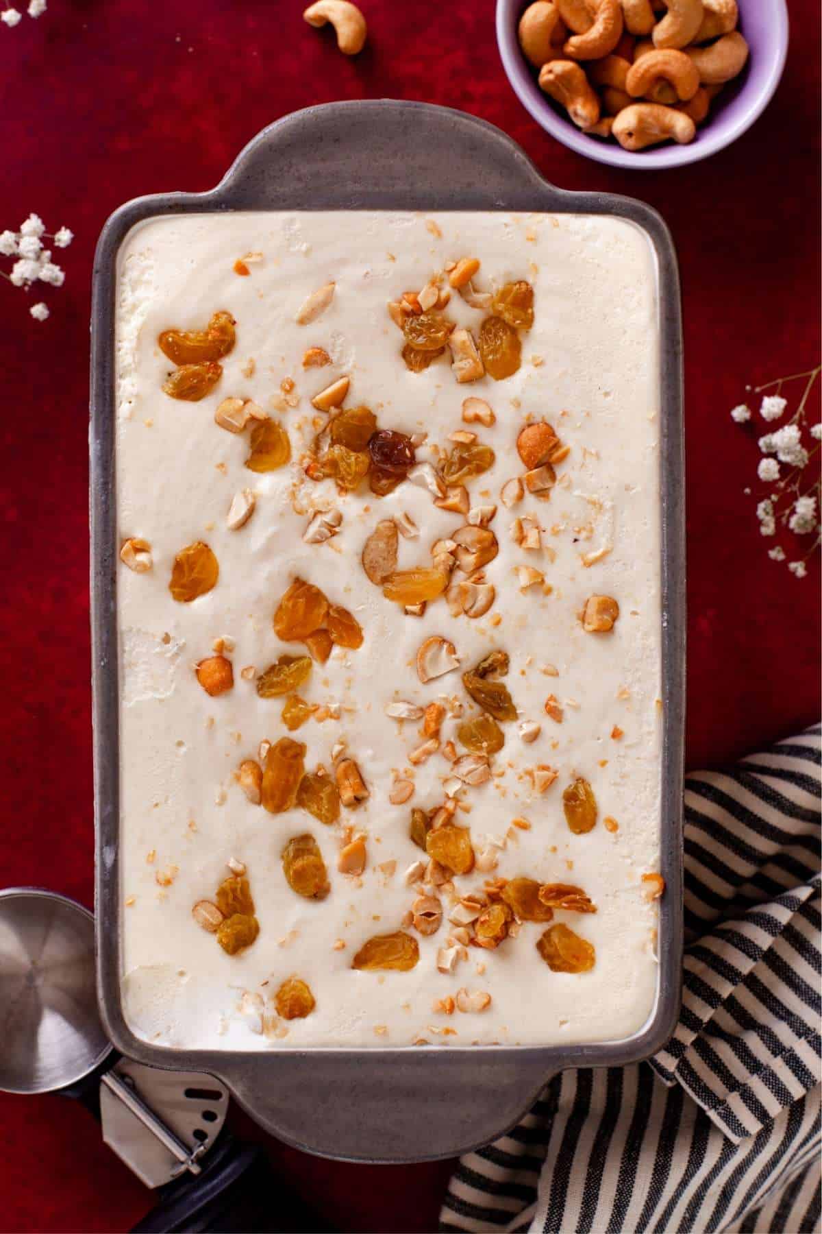 No Churn Cashews & Raisins Ice cream in a grey and white load pan.