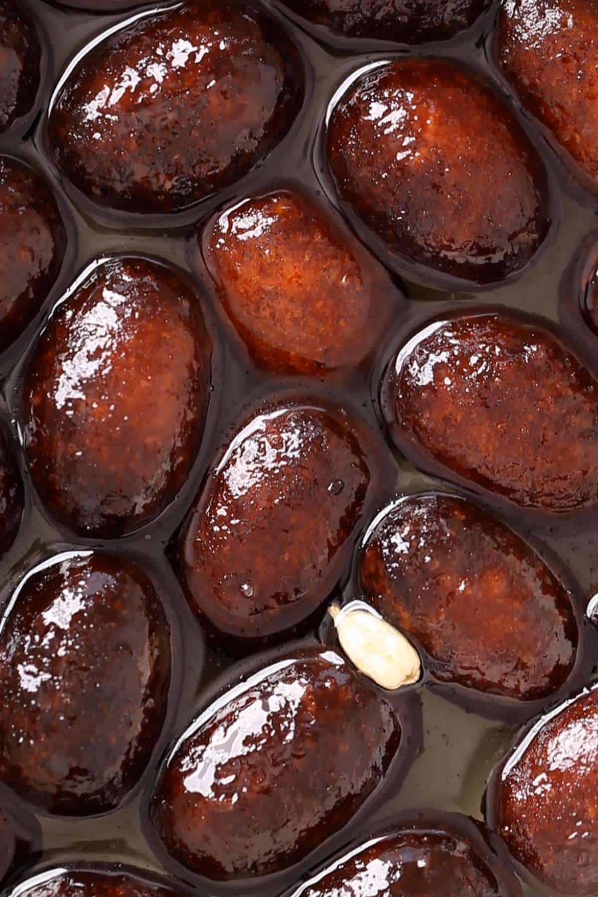 Kala Jamun Dunked in sugar syrup.