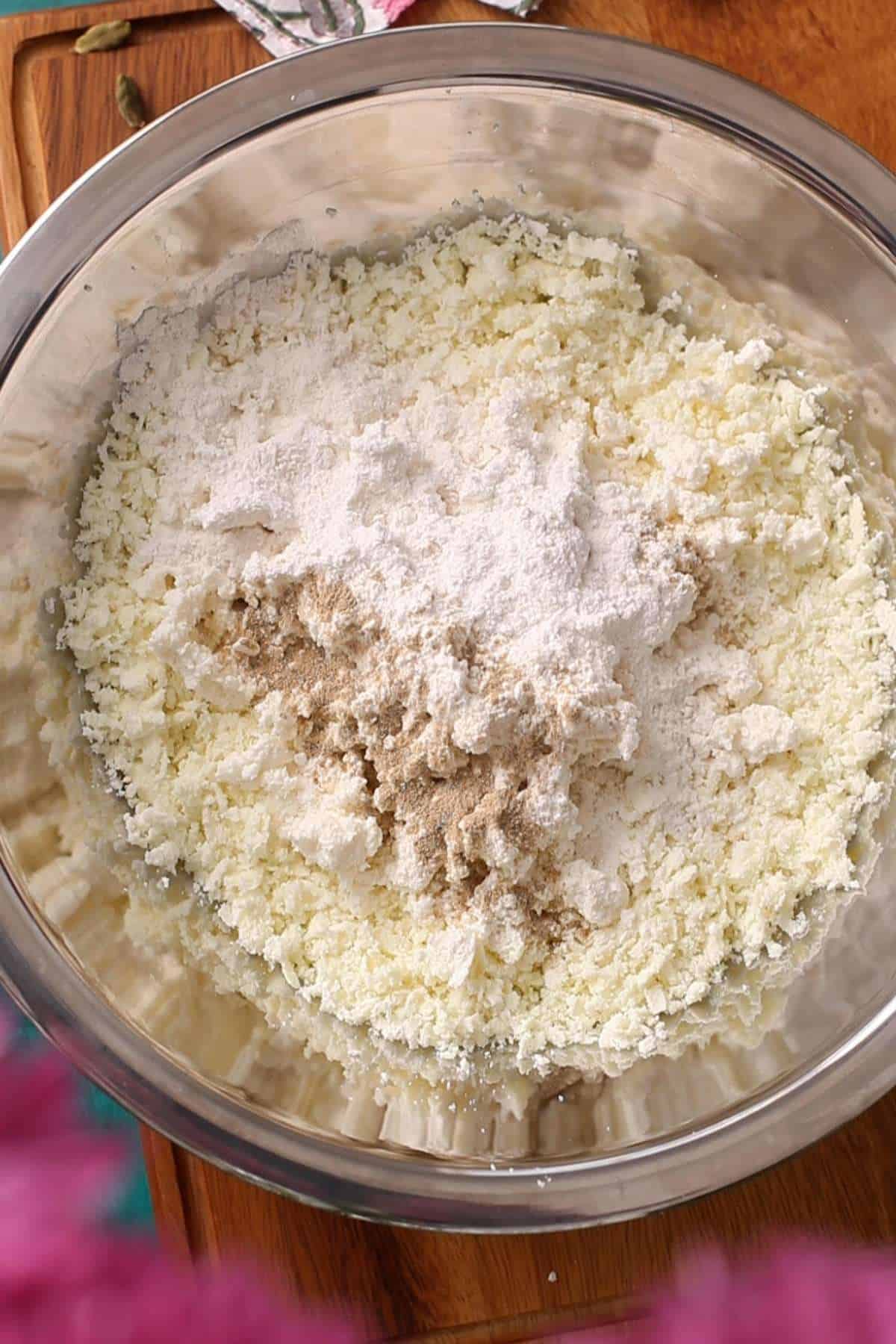 All the ingredients needed to make kala jamun are in a steel bowl.