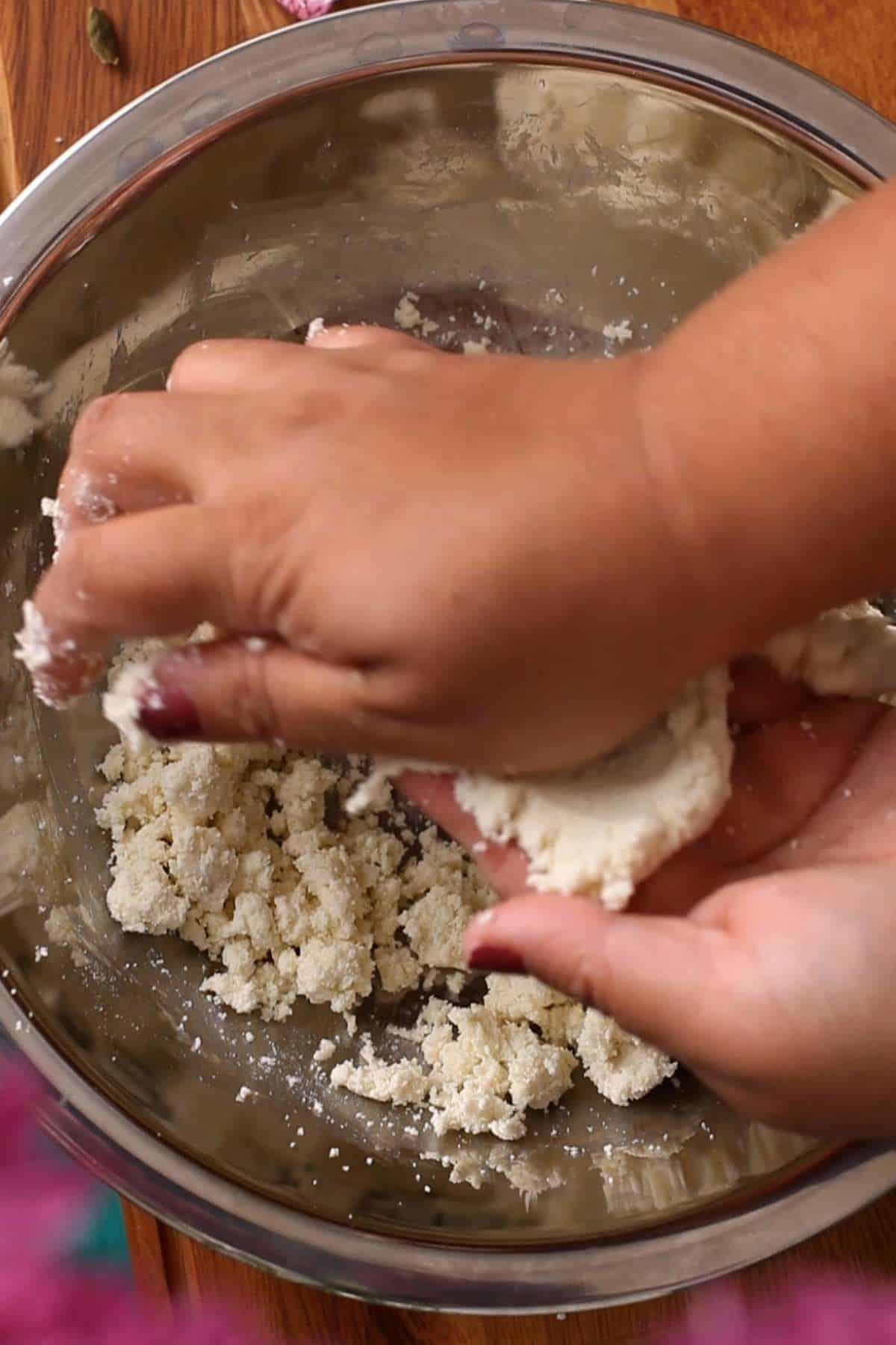 Mashing the jamun dough.