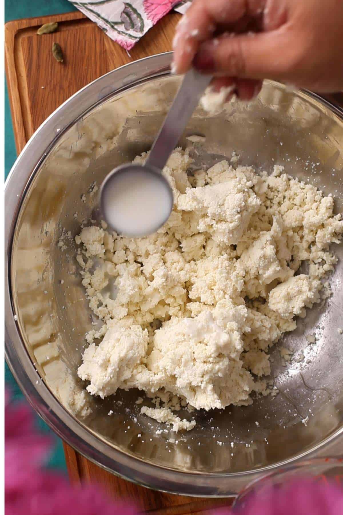 Adding milk to make the dough.