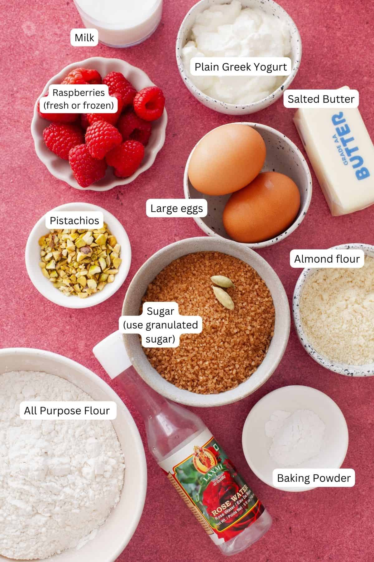Ingredients for rose water cake on a pink background.
