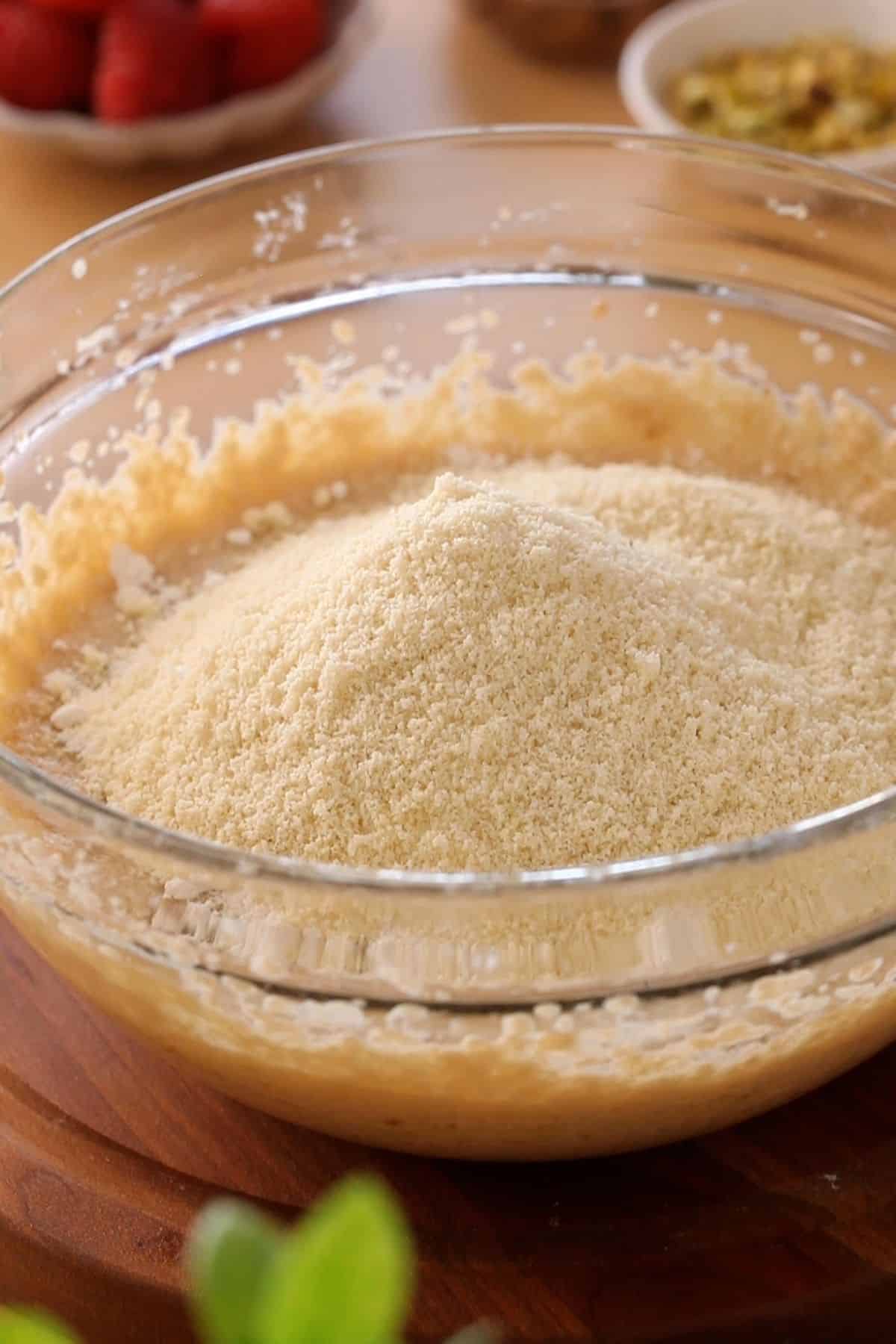 Dry ingredients are added to wet ingredients in mixing bowl.