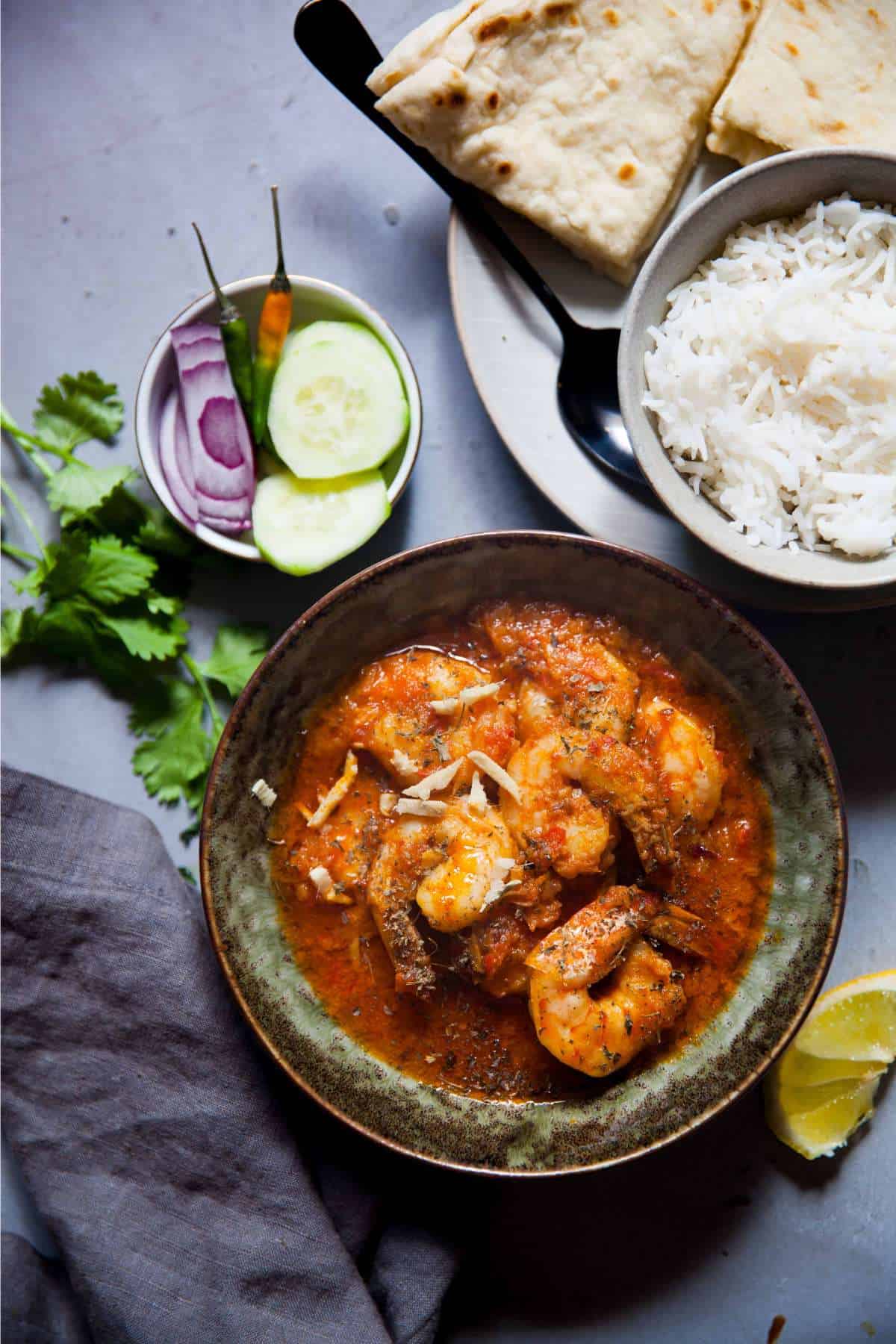 Shrimp curry served with plain rice, naan and salad. 