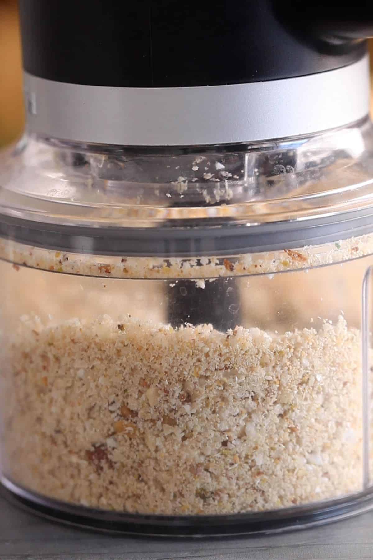 Nuts are crushed in a food processor.
