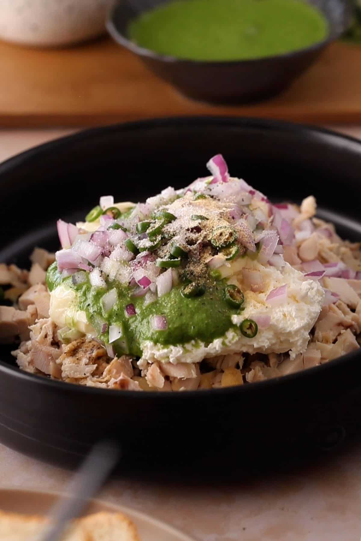 Onions, spices and green chilies are added to the chicken filling.
