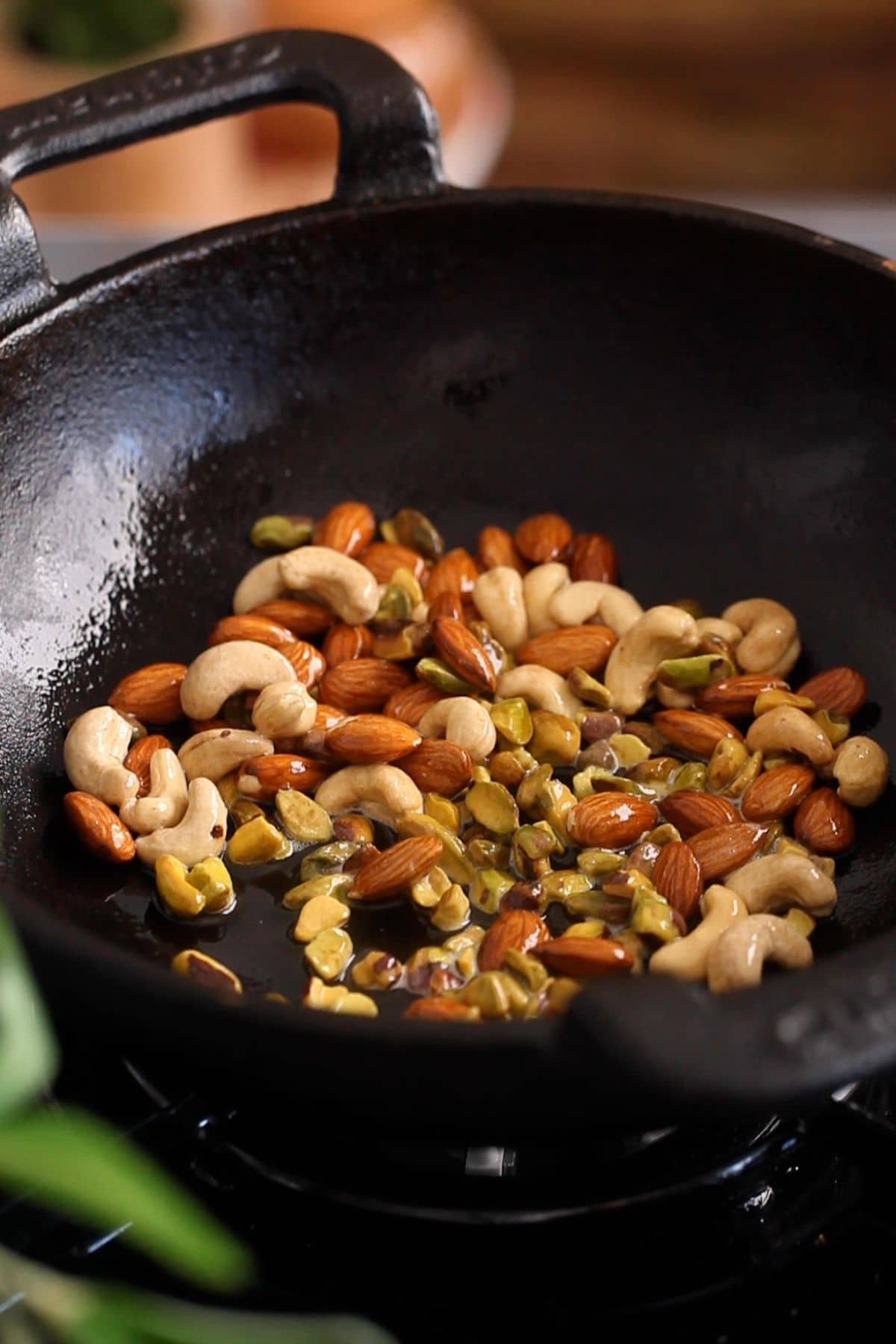 Roasting nuts in an iron kadai.