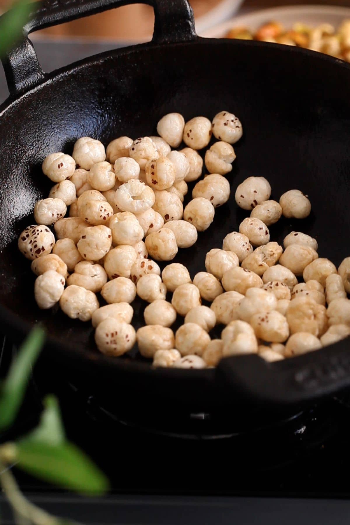 Roasting fox nuts in ghee in iron kadai.