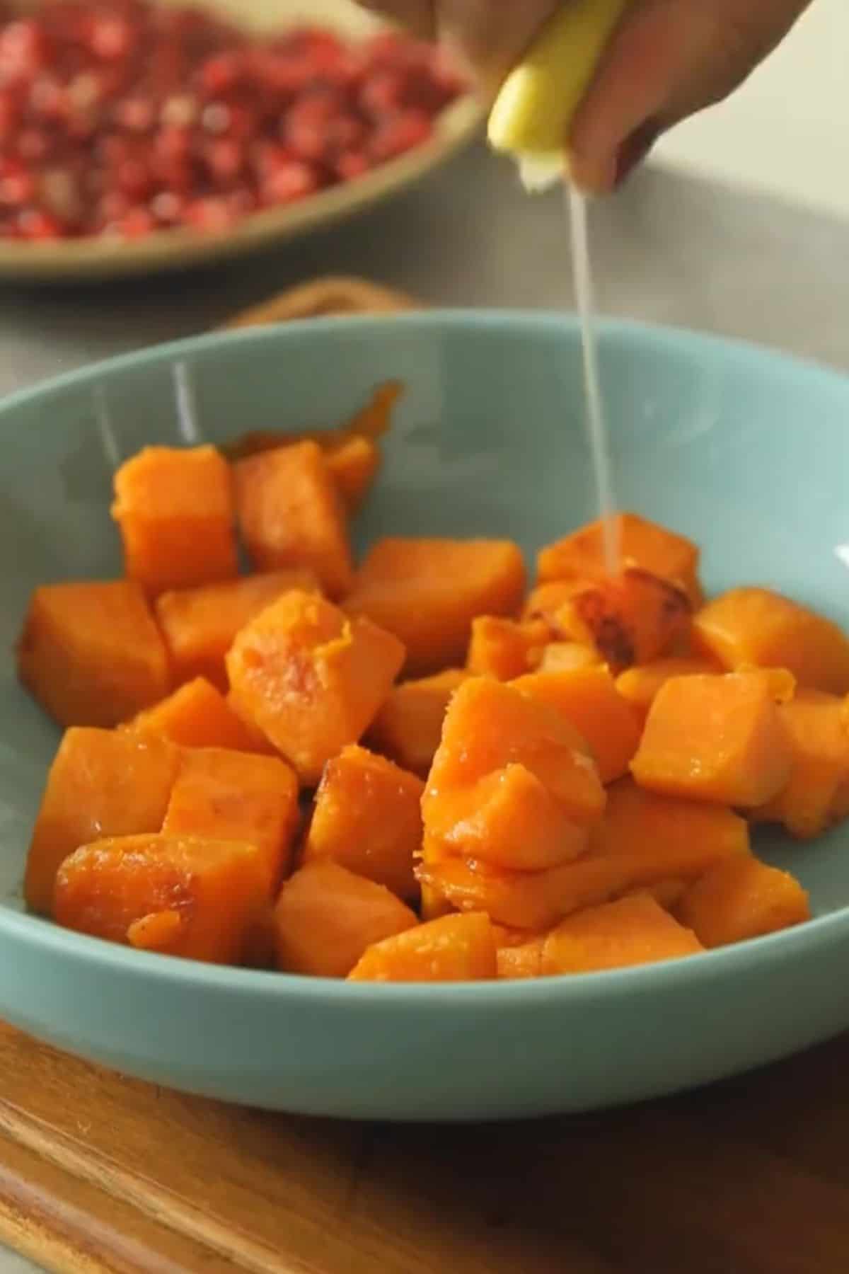 Squeezing lemon juice over shakarkandi.