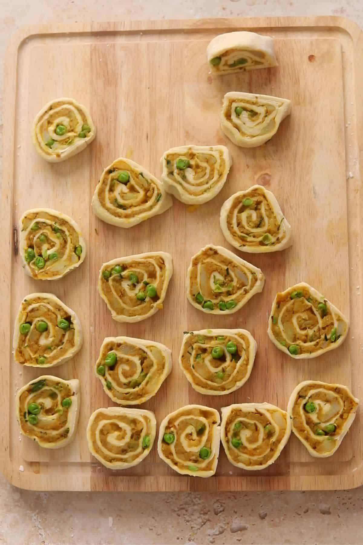 Pinwheels are cut and placed on the wooden board. 