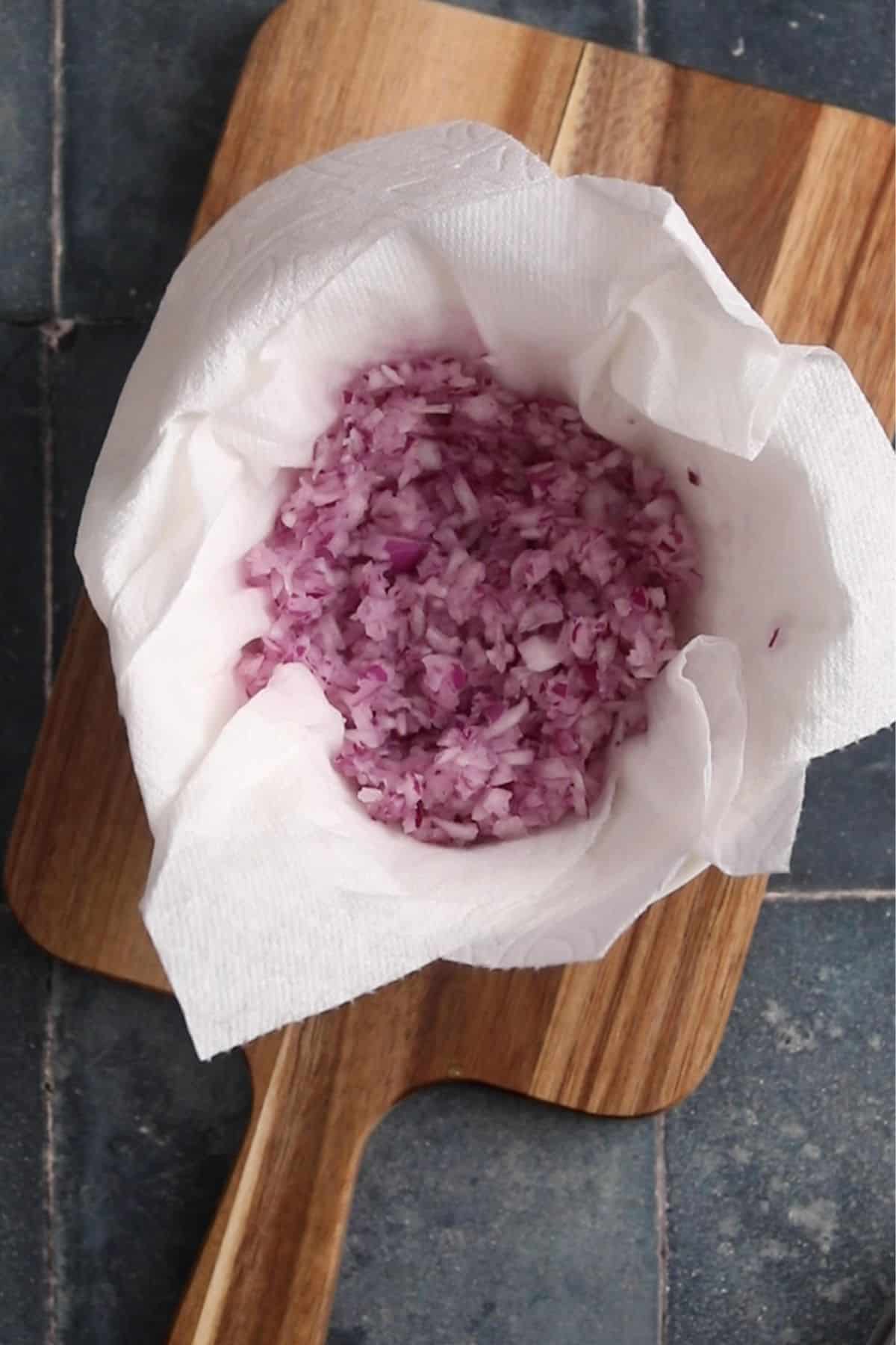 Chopped onions are placed on paper towel to drain.