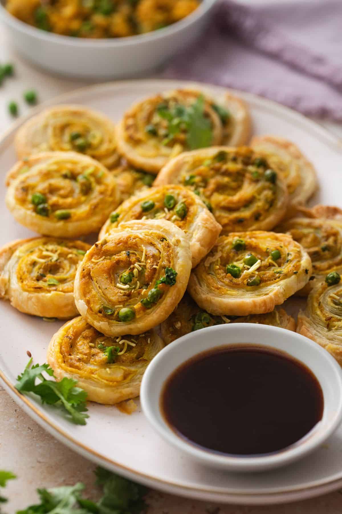 Potato & pea samosa pinwheels served with tamarind chutney.