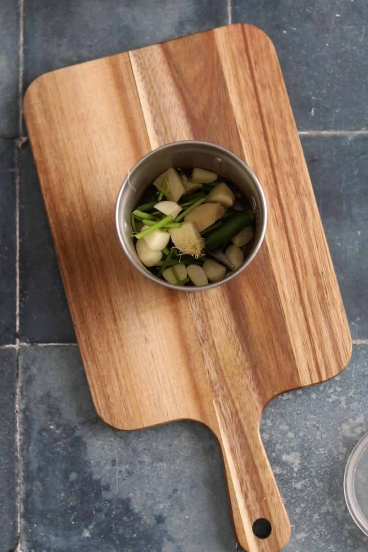 Aromatics are added to a small stainless steel grinder.